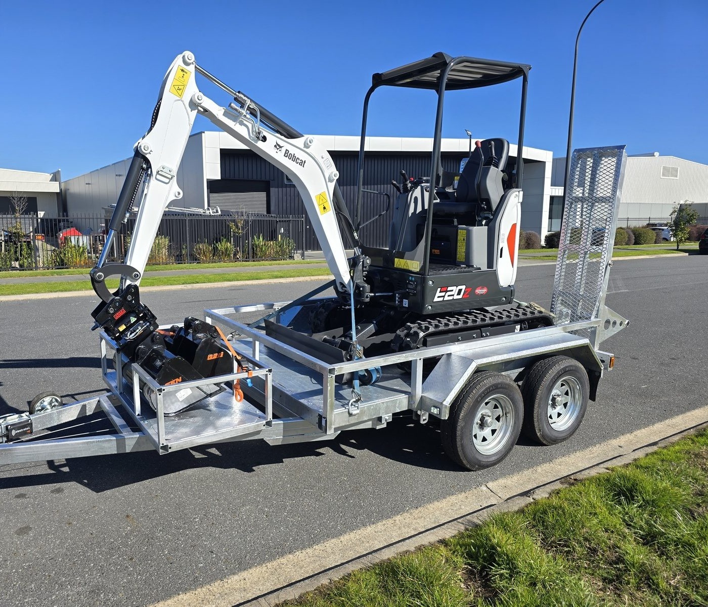 Bobcat E20z mini excavator on tandem trailer with bucket set